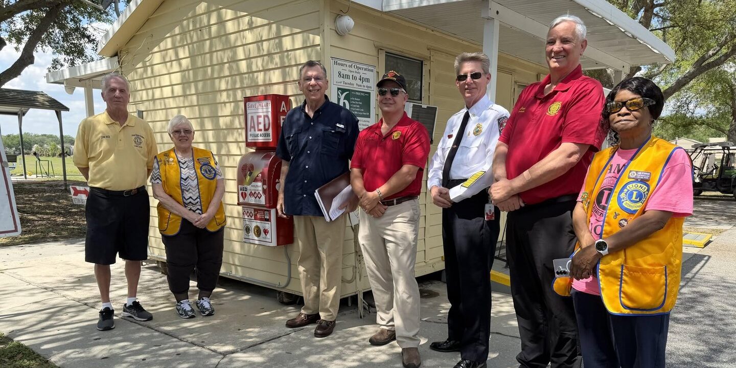Leaders from the Lions Club of Orange Blossom Gardens/Lady Lake, American Legion Post 347, Advocates for Early Defibrillation and Lake County Fire Rescue with the new SaveHeart by HeartNation Wall-Mount at the Bob Johnson Legacy Driving Range