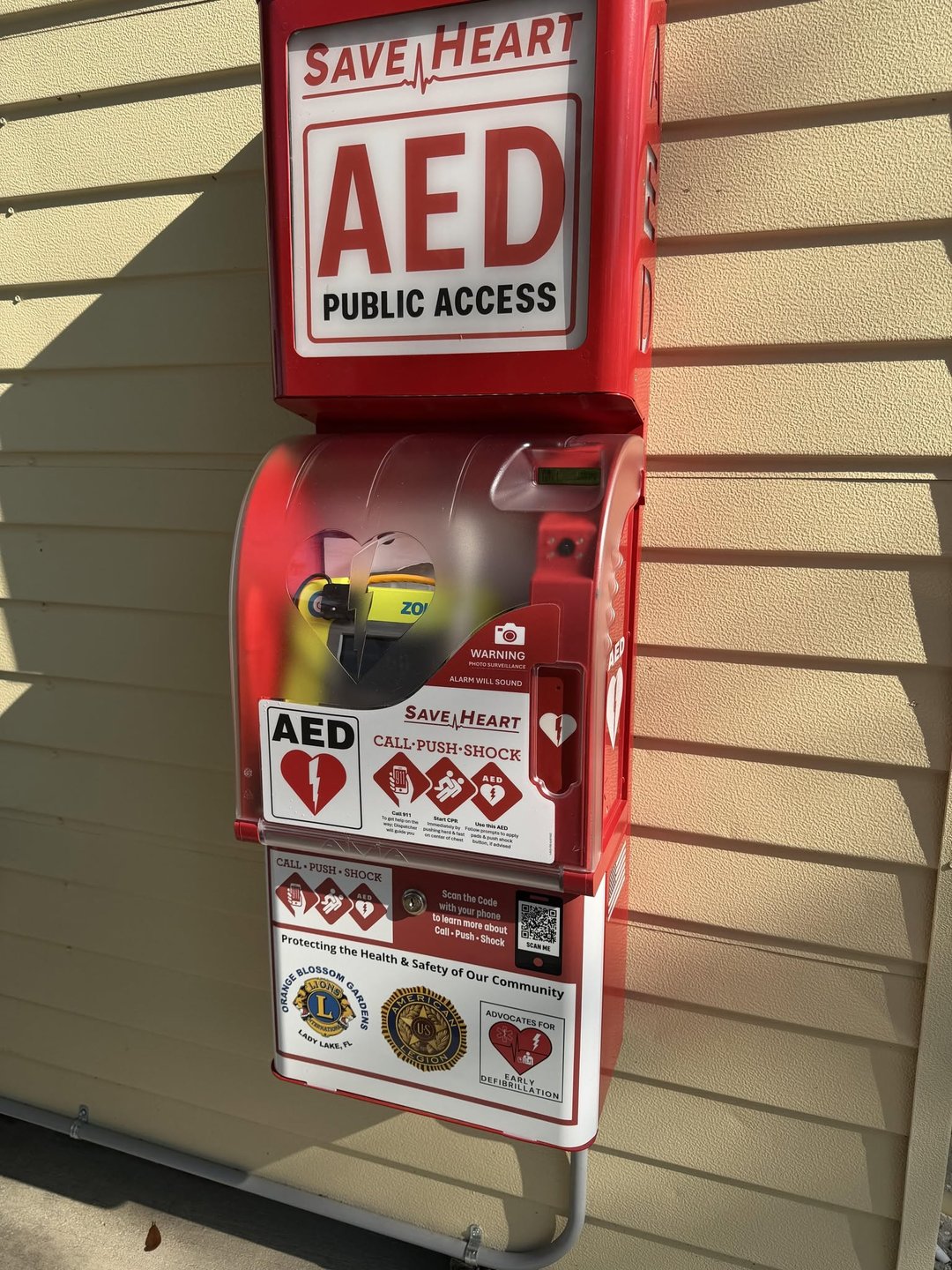 SaveHeart by HeartNation Wall-Mount AED cabinet with Lions Club and American Legion sponsor panel on the ball shack at the Bob Johnson Legacy Driving Range