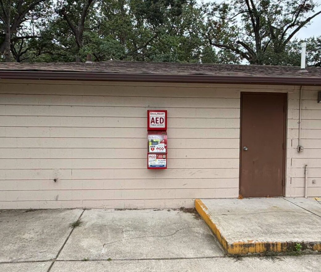 SaveHeart by HeartNation Wall-Mount AED cabinet on the outside wall of a park building at Woodland Park in Portage